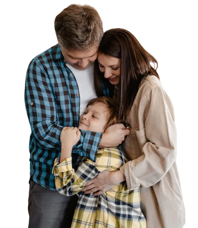 Loving parents embracing their young son closely at home during a Navigating Family Estrangement Therapy healing journey.